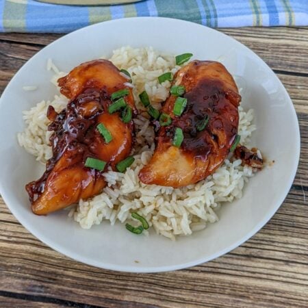 brown sugar garlic chicken on a white plate with rice